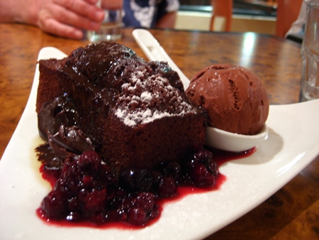 Warm chocolate pudding with fresh berry sauce and a scoop of choc icecreamy.